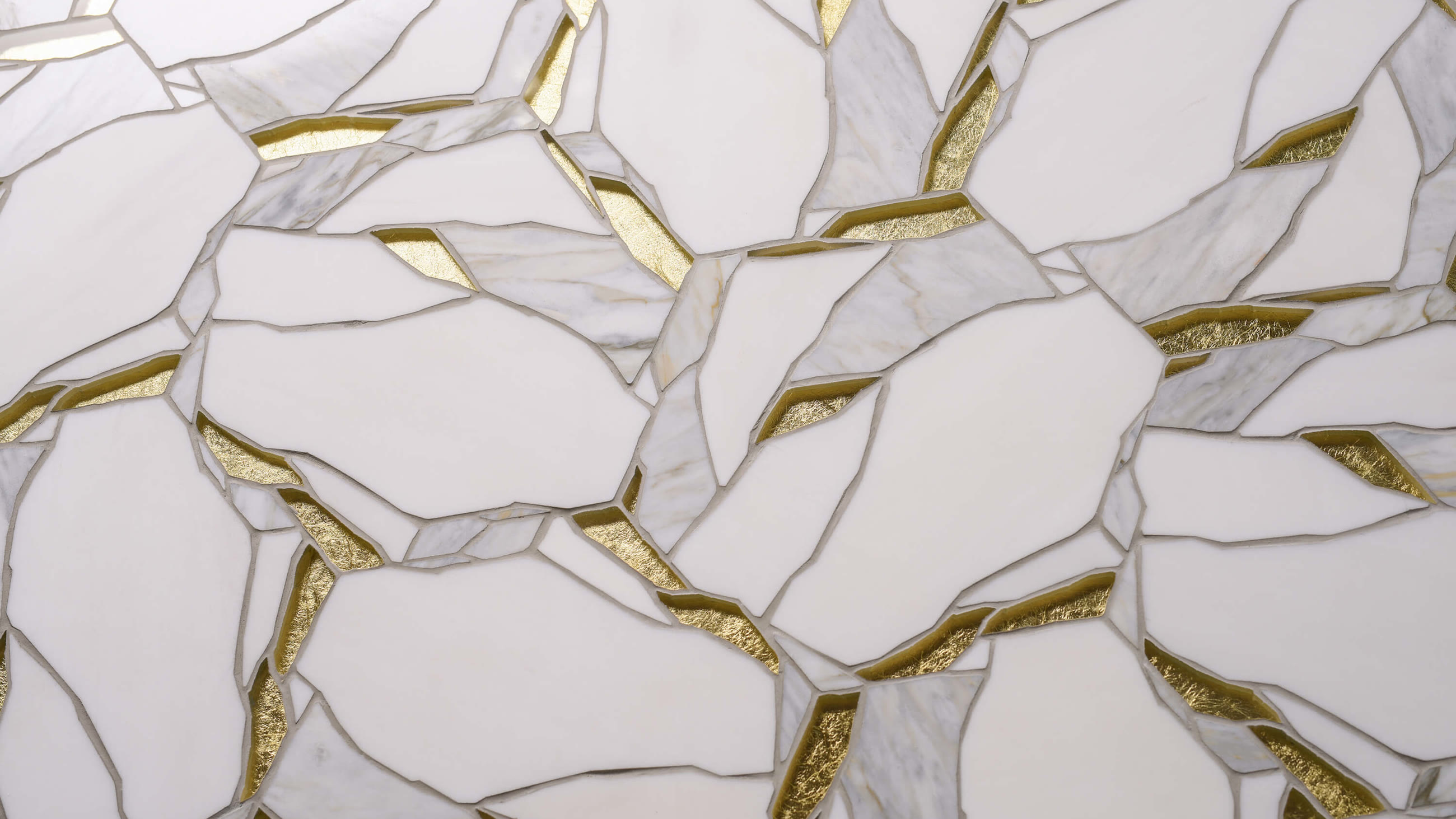 Wabi-sabi material pattern of fragmented white marble joined with gold