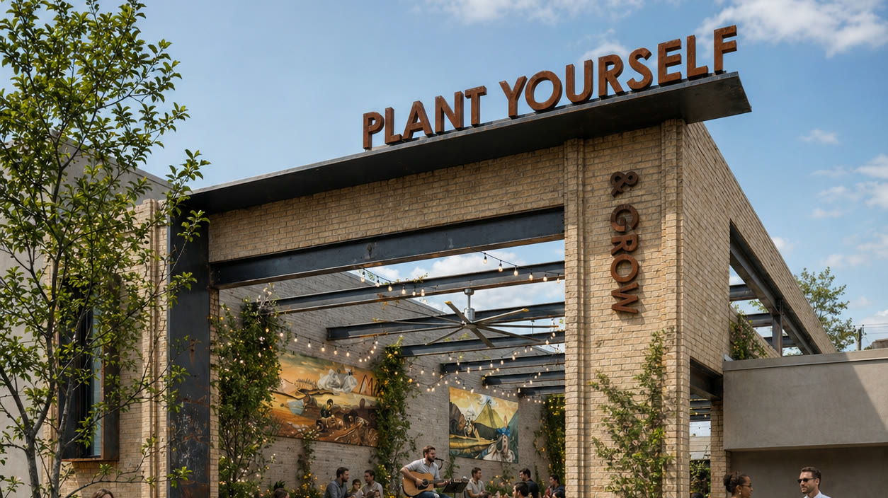 Lively planted public courtyard framed by a brick market building
